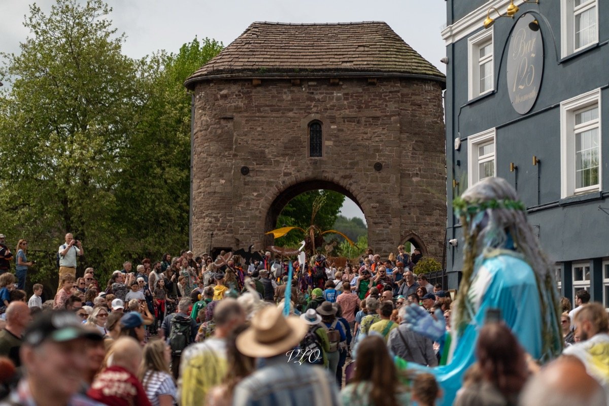 Crowd gathered at a festival beside the Monnow Bridge gate in Monmouth