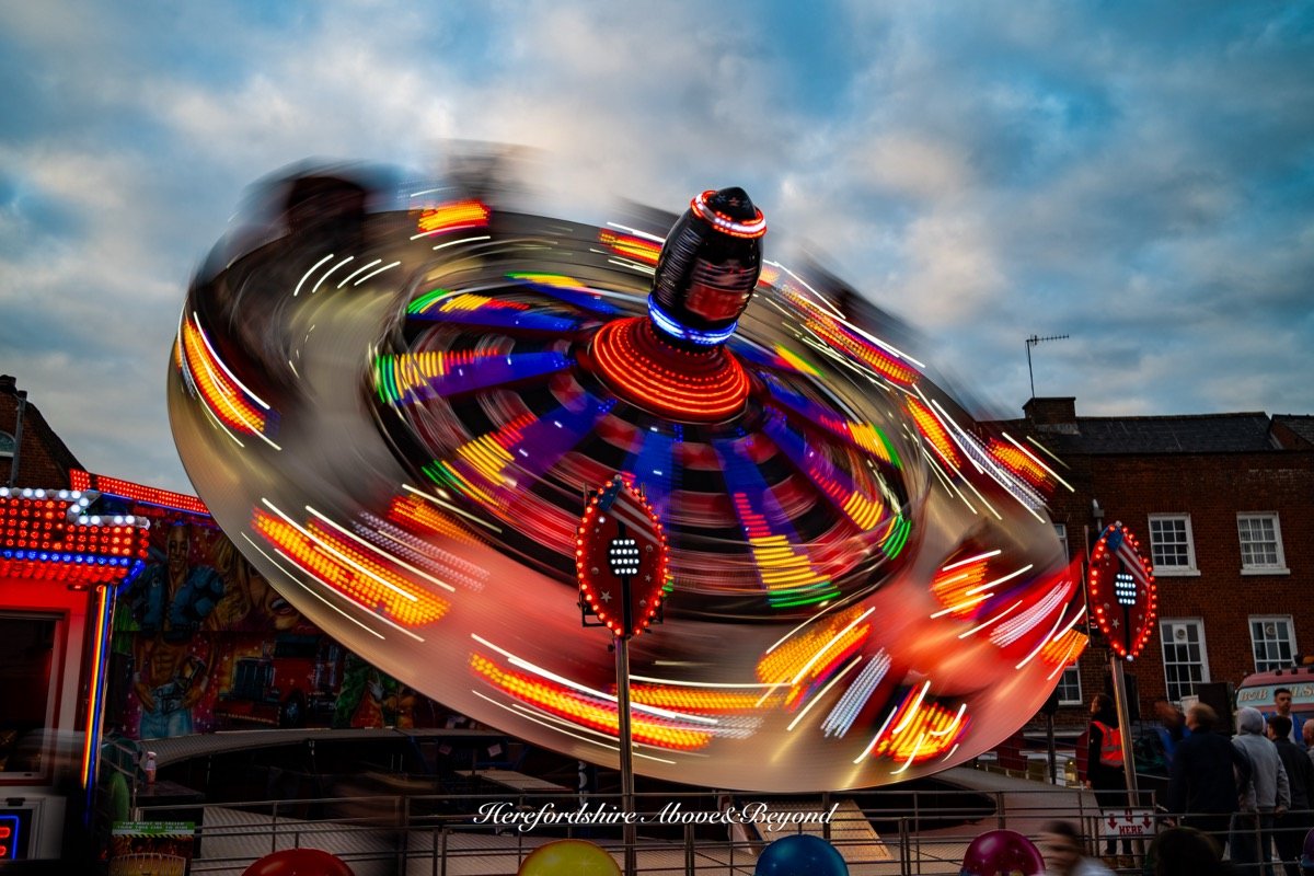 Fairground ride captured as light trails