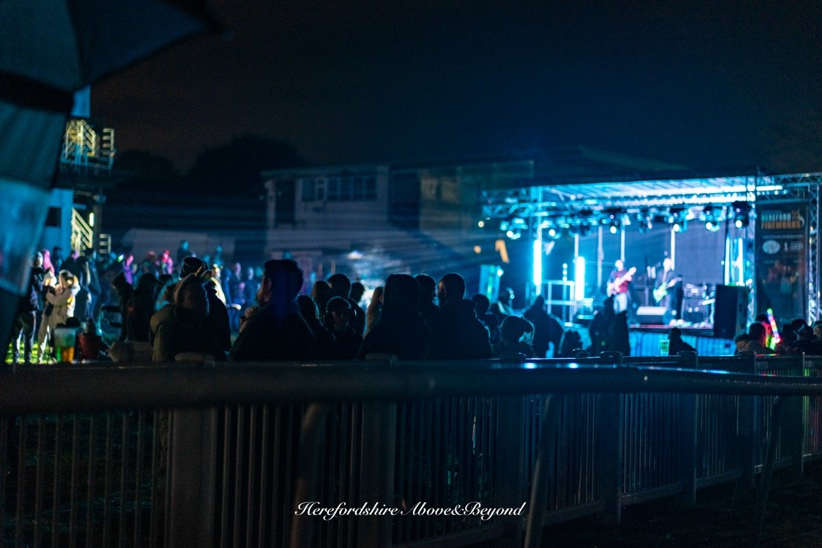 Crowd watching a live band on an outdoor stage at night