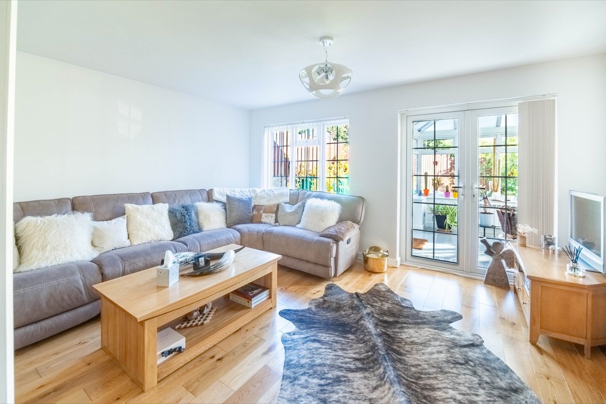 Living room with corner sofa and oak flooring