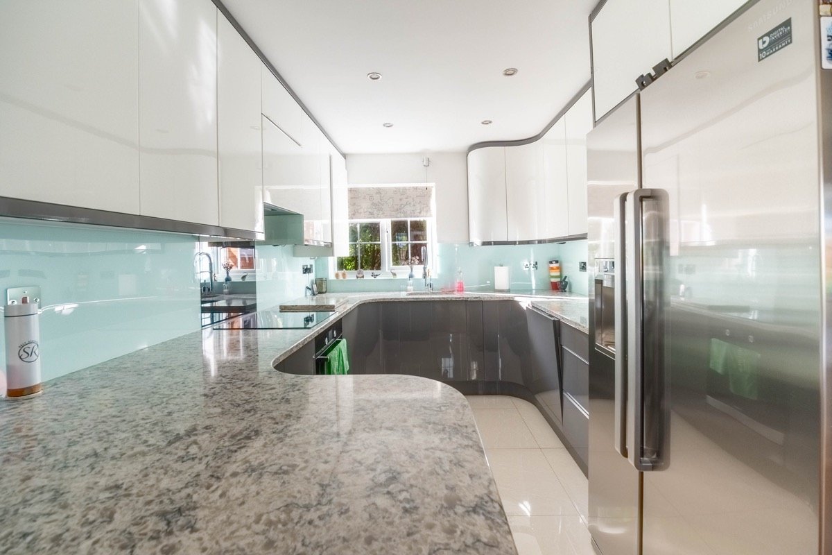 Kitchen with glass splashback and granite worktop